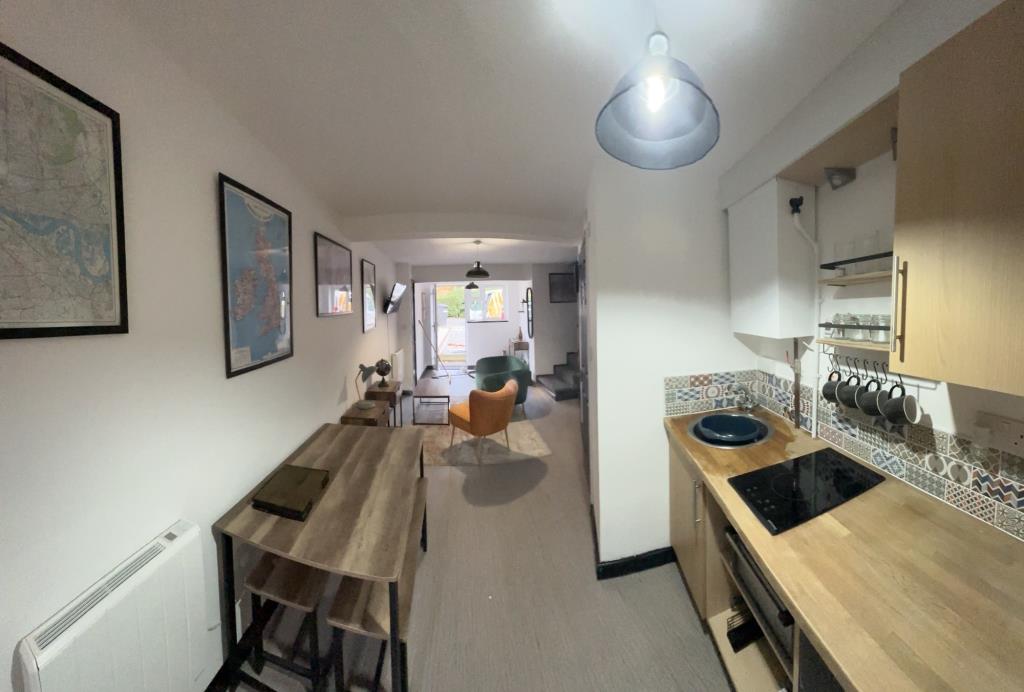 Lot: 70 - TOWN CENTRE BUILDING WITH OFF-ROAD PARKING - View back to front of property on ground floor